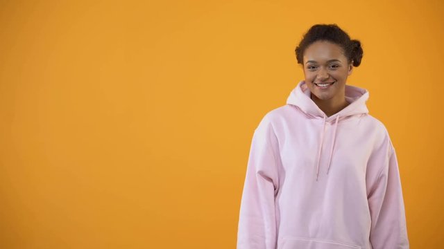 Teenage african american girl bragging with new over-sized hoodie, fashion
