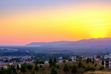 Selcuk, Turkey. Panorama of the view of the city and the mountains at sunset.