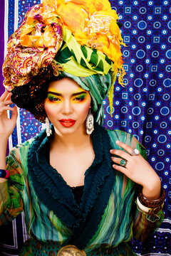 beauty bright woman with creative make up, many shawls on head like cubian woman