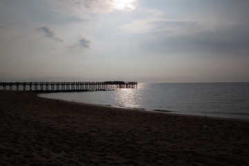 Sunset on the sea with a pier in the background