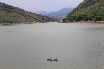 Fishermen on a canoe on a large lake
