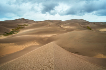Fototapeta na wymiar Sand Dunes with Dramatic Clouds 