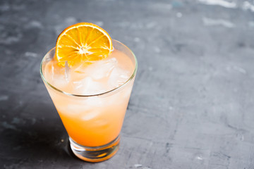 Fresh cocktail with grapefruits on the rustic background. Selective focus. Shallow depth of field.