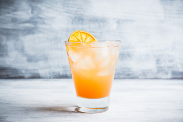 Fresh cocktail with grapefruits on the rustic background. Selective focus. Shallow depth of field.