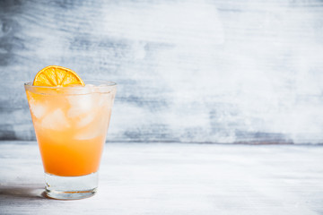 Fresh cocktail with grapefruits on the rustic background. Selective focus. Shallow depth of field.