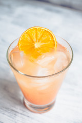Fresh cocktail with grapefruits on the rustic background. Selective focus. Shallow depth of field.