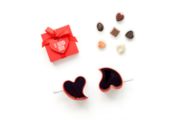Gift for Valentine's day. Gift box with text I love you and heart-shaped sweets on white background top view copy space