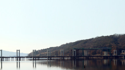 Naklejka premium The bridge is being built to cross the river.