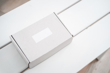 Craft box on white table from above. Product packaging, branding mockup, delivery service.