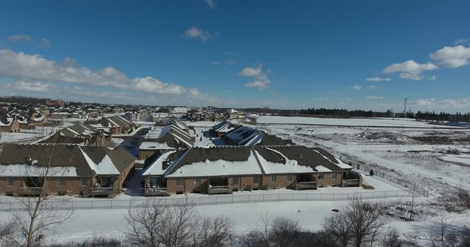 Flying From Forest To Snow Covered Rooftops In Winter Low Level Flying Angle Aerial