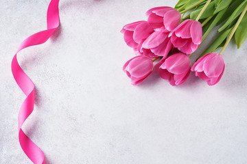 Valentine's Day background with pink tulips and ribbon.