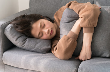 asian female sleeping on sofa