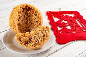 cut out  traditional Chinese fried sesame ball with a label on back English translation of...