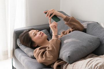 Obraz na płótnie Canvas Relaxed woman lying on comfortable sofa