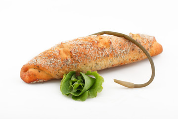 Baguette with wild garlic and leaf salad on white background