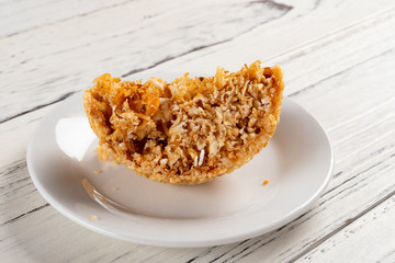 section of traditional Chinese fried sesame ball on white wood table