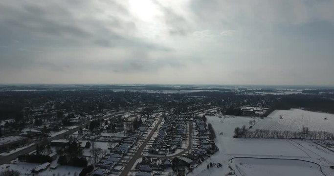 Pan Left To Right Of Housing Near Forest In Winter Aerial View