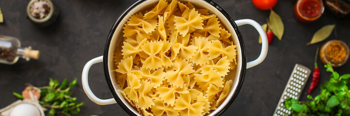 pasta, farfalle and sauce ingredients (set). food background. copy space