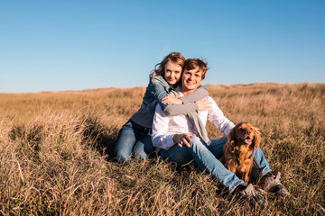 Fototapeta premium Happy young couple hugging and laughing outdoors.