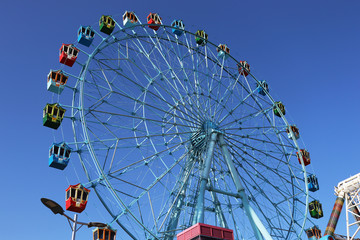 Ferris wheel against the blue sky