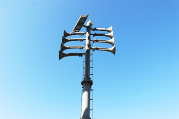 trumpet-shaped speaker against the blue sky