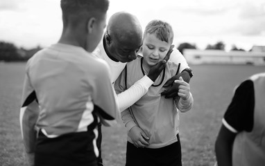 Football coach with his students