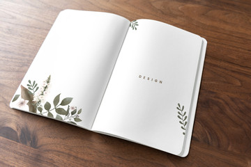 Floral notebook mockup on a wooden table