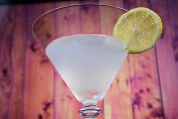 White Lady Cocktail in martini glass decorated slice of lemon