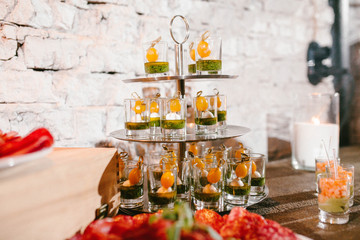 beautiful appetizer in cups on a tray
