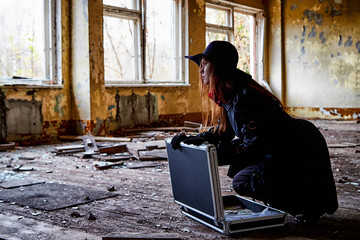 Girl in a black cloak with a diplomat and money in a ruined room. A spy in a secret meeting....