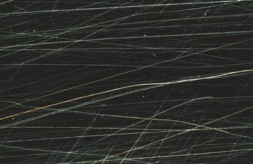 Scratched film texture. Many bright lines in different directions on a dark background. Perfect for grunge design.