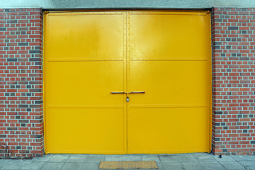 A large yellow gate made of iron