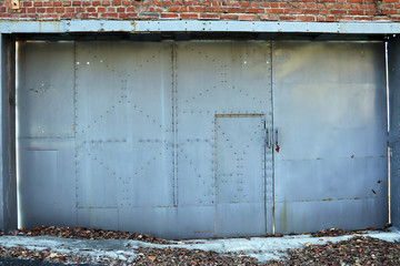 Red brick walls and grey iron door