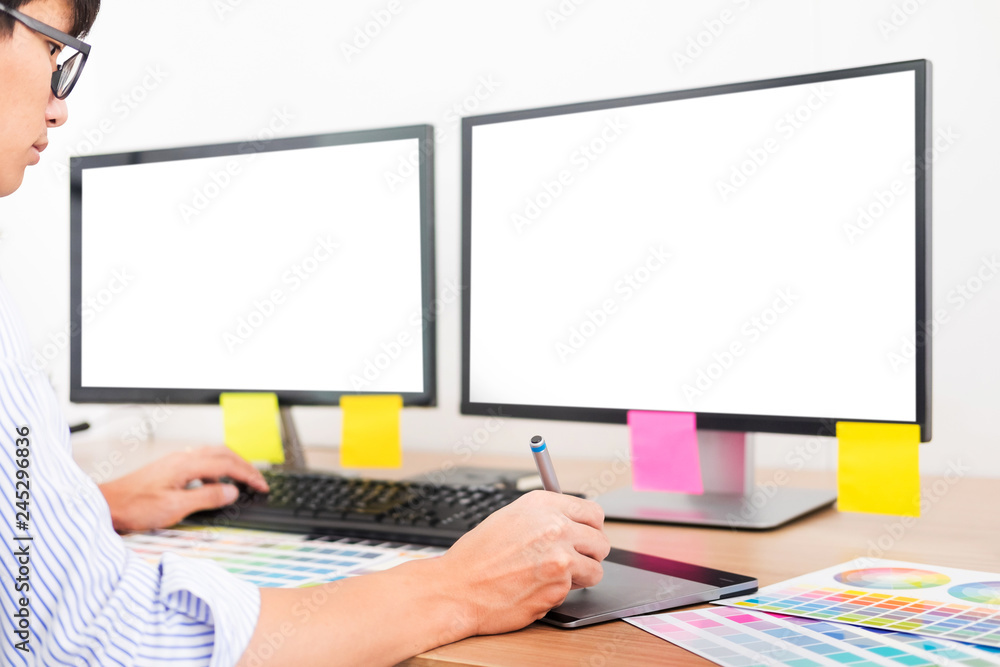 Aufkleber designer editor at work drawing sketches a new project on graphic tablet and color palette sitting a