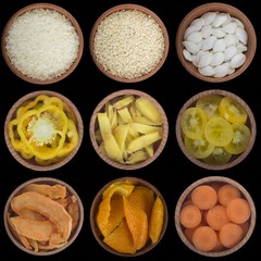 set of white, yellow and orange spices and vegetables isolated on black background