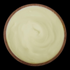 mayonnaise in wooden cup isolated on black background. top view