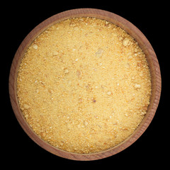 ground dried rind of orange  in wooden cup isolated on black background. top view