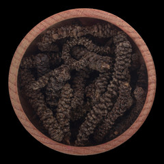 Piper capense in wooden cup isolated on black background. top view