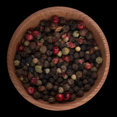 set of peppercorn in wooden cup isolated on black background. top view