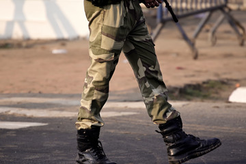 Security guard with rifle standing on outside to protect the area.