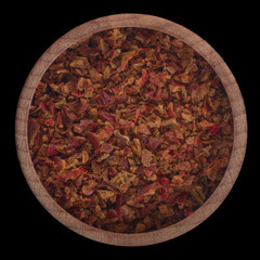 ground dried red pepper in wooden cup isolated on black background.  top view