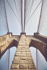 Looking up at Brooklyn Bridge, color toned picture, NYC.