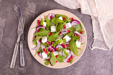 Healthy salad with spinach, arugula, red onion and pomegranate