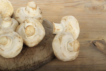 heap of champignons on wooden background