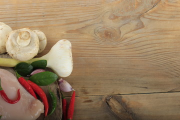 champignons with spices on wooden background