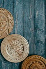 wooden decoration A rounded detailed plate hanging on the wall beautiful plates on a dark wooden background 