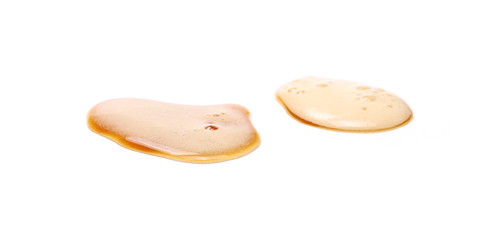 Spilled beer puddle with foam isolated on white background and texture