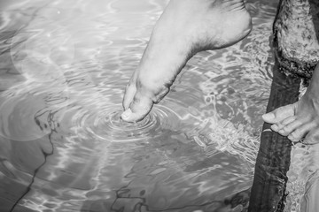 Fototapeta premium beautiful legs of a girl near a swimming pool on the sea background
