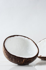 Half a fresh coconut on a white background