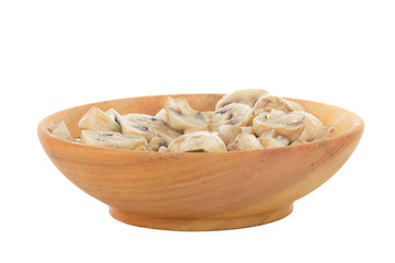 heap of champignons in wooden plate isolated on white background